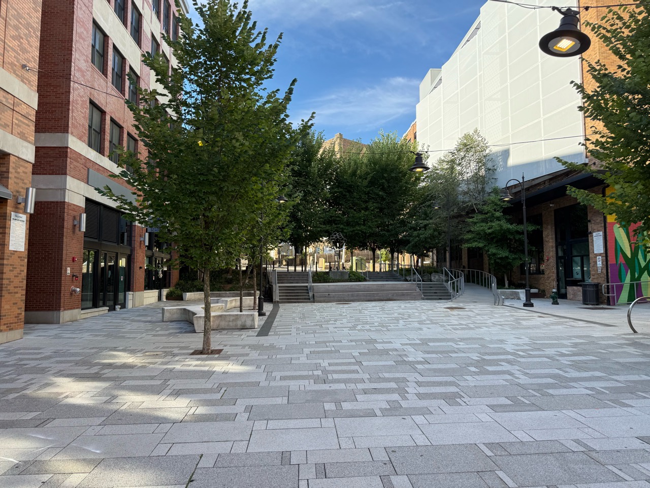 Trees, seating and steps in the plaza beside the Wellmont.