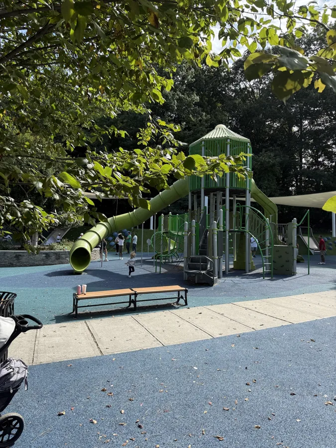 Tall green tube slide at the Verona Park playground